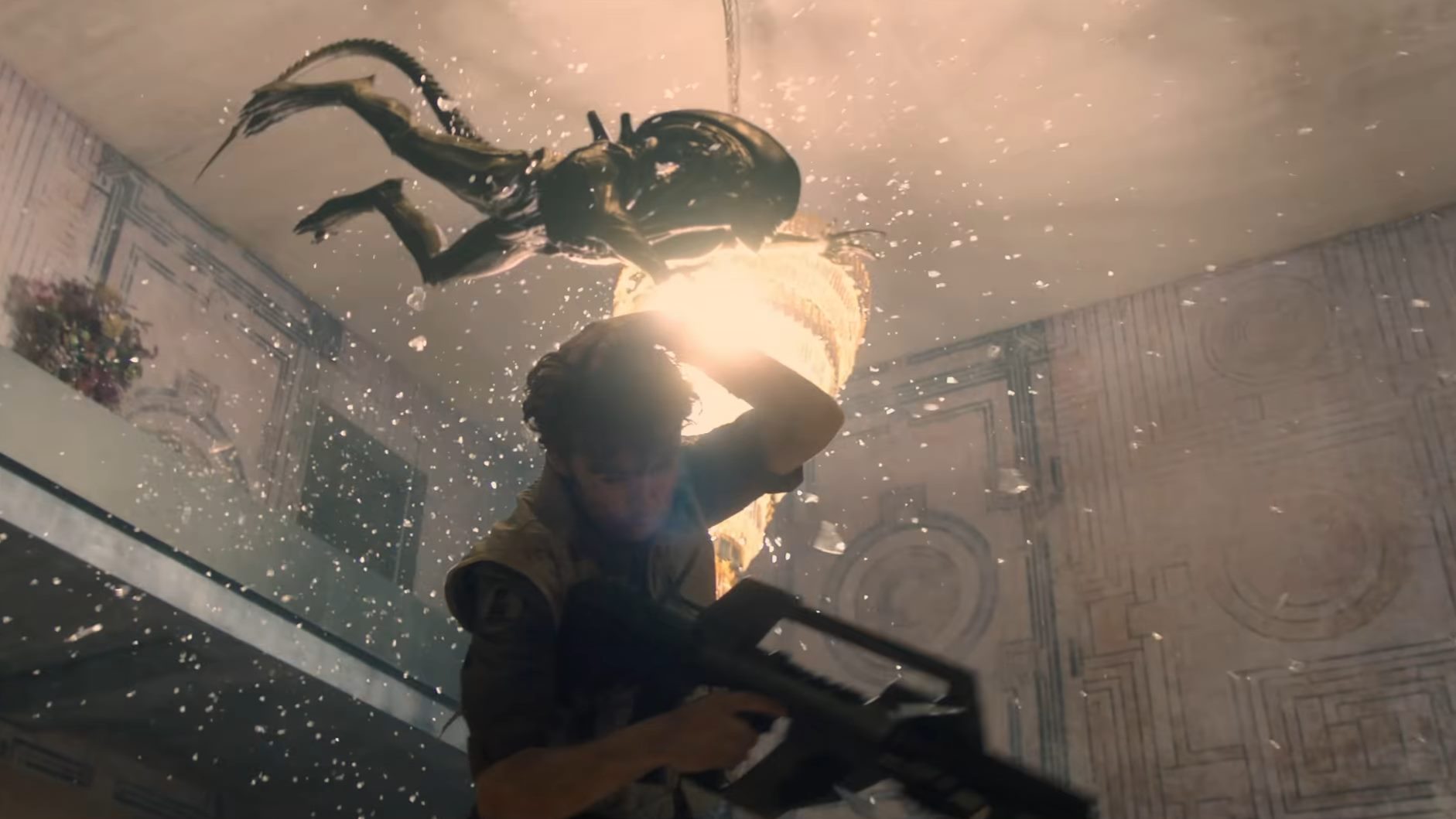Joe attempts to fight off the Xenomorph inside of an apartment, only to get surprise attacked by it jumping off the second floor.
